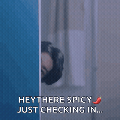 Man Peeking Behind Wall Saying Hey There Spicy GIF