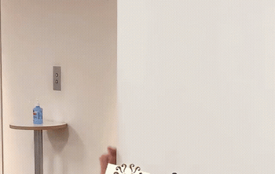 Man Peeking From Behind Wall GIF