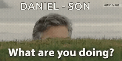 Man Peeking From Green Field Asking What Are You Doing GIF