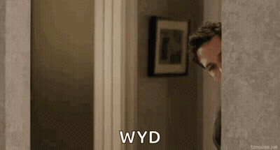 Man Peeking Out Doorway Saying WYD GIF