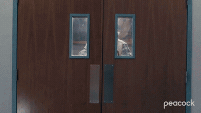 Man Peeking Through Wooden Doors GIF