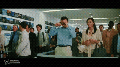 Man Photographing Woman In Crowded Area With Foreign Text GIF