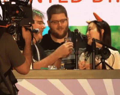 Man Photographs Man And Woman At Microphones GIF