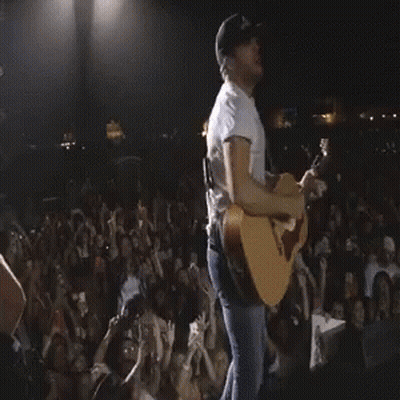 Man Playing Acoustic Guitar In Front Of Crowd GIF