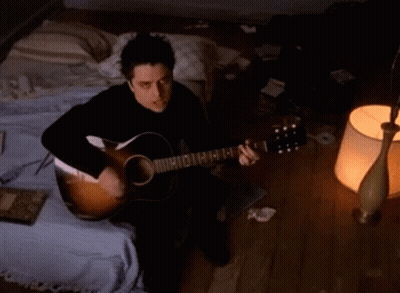 Man Playing Acoustic Guitar With E On Neck GIF
