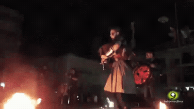 Man Playing Bagpipe In Front Of Crowd GIF