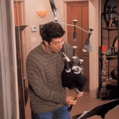 Man Playing Bagpipe On Exercise Bike GIF