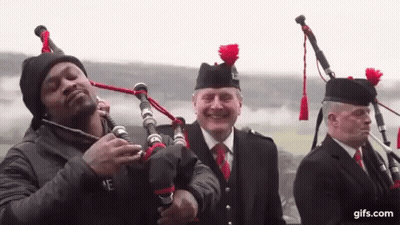 Man Playing Bagpipe With Kilted Men GIF