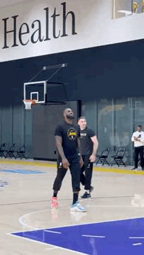 Man Playing Basketball In Front Of Health Sign GIF