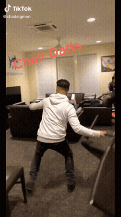 Man Playing Chair Darts GIF