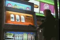 Man Playing Coin Slot In Vegas Vacation GIF