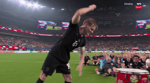 Man Playing Drum On NRK Soccer Field GIF
