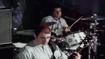 Man Playing Drums And Man Playing Guitar On Stage GIF