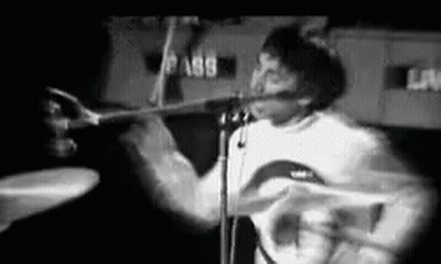 Man Playing Drums And Singing On Stage Black And White GIF