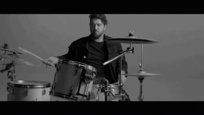 Man Playing Drums in Black and White