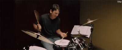 Man Playing Drums In Dark Room GIF