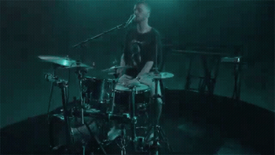 Man Playing Drums In Dark Room GIF