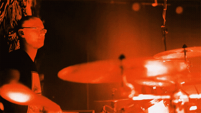 Man Playing Drums In Dark Room GIF