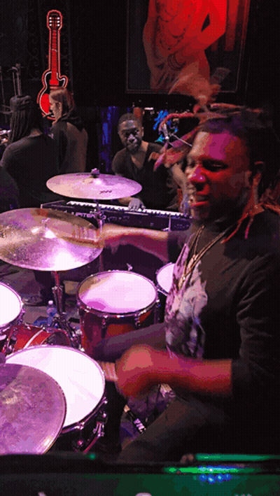 Man Playing Drums In Dark Room With Guitar GIF