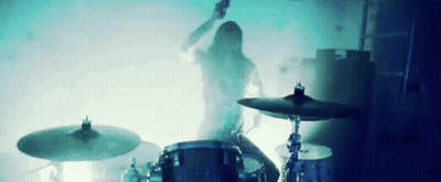 Man Playing Drums In Dark Room With Smoke GIF