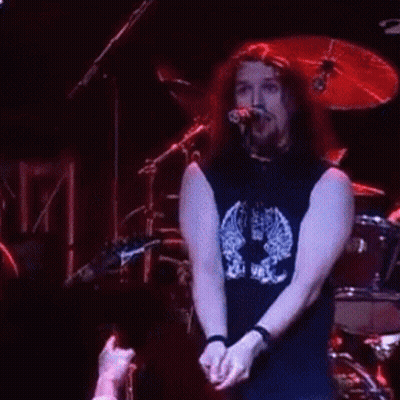Man Playing Drums In Front Of Cheerleader GIF