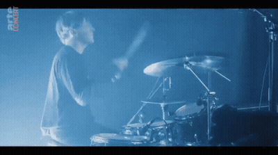 Man Playing Drums In Front Of Digital Content Screen GIF