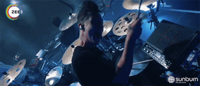 Man Playing Drums In Front Of Sunburn Advertisement GIF