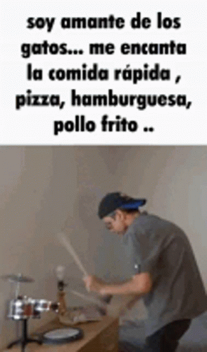 Man Playing Drums In Front Of Table With Spanish Quote GIF
