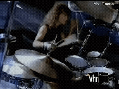 Man Playing Drums In Front Of VH1 Rocks Logo GIF