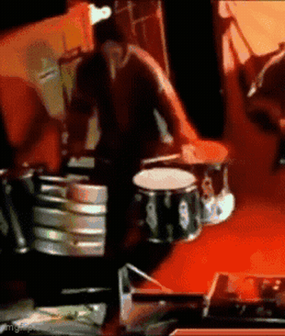 Man Playing Drums On Red Background GIF