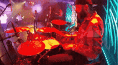 Man Playing Drums on Stage