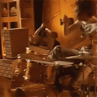 Man Playing Drums While Woman Looks On GIF