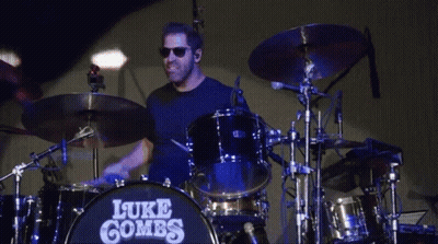 Man Playing Drums With Name Luke Combs GIF