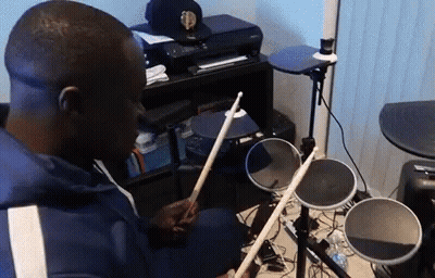 Man Playing Electronic Drums In Living Room GIF
