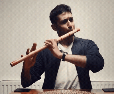 Man Playing Flute By Radiator Wearing Watch GIF