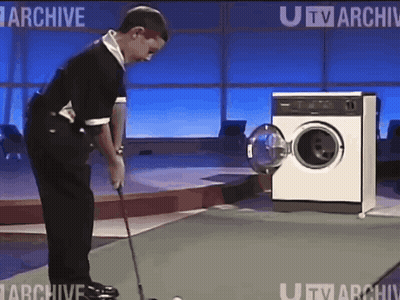 Man Playing Golf In Front Of Washing Machine GIF