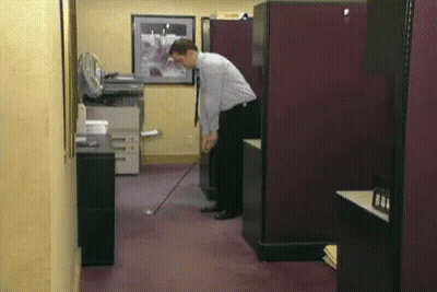 Man Playing Golf In Office GIF