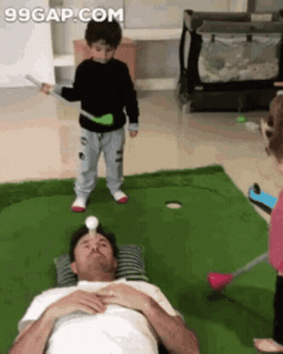 Man Playing Golf With Boy Standing Beside
