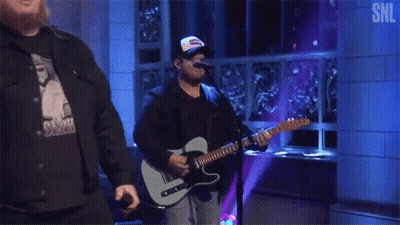 Man Playing Guitar And Singing Into Microphone GIF
