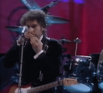 Man Playing Guitar And Singing Into Microphone With Harmonica GIF