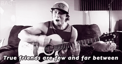 Man Playing Guitar And Singing On Couch GIF