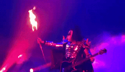 Man Playing Guitar Blowing Flames On Stage GIF