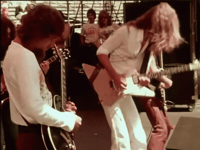 Man Playing Guitar For Crowd In BB Shirt GIF