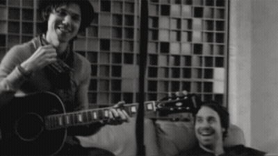 Man Playing Guitar In Black And White Photo GIF