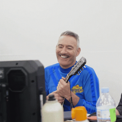 Man Playing Guitar In Blue Wiggles Shirt GIF