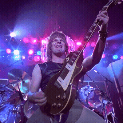 Man Playing Guitar In Dark Room With Purple Lights GIF
