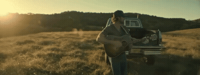 Man Playing Guitar In Field With Truck GIF