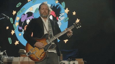 Man Playing Guitar In Front Of Cartoon Girl GIF