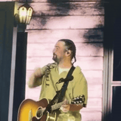 Man Playing Guitar In Front Of Door GIF