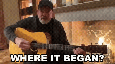 Man Playing Guitar In Front Of Fireplace Where It Began GIF